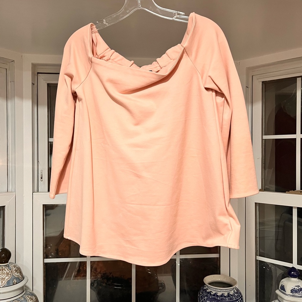 Worn only once this beautiful pink off the shoulder shirt could yours.
